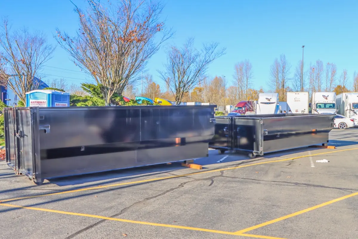 Professional dumpster rental service with roll-off container on residential driveway in Tooele